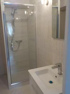 a bathroom with a shower and a white sink at Villa Petra in Sainte-Maxime