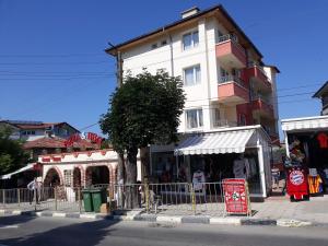 a building on the side of a street with a store at Guest House Perla in Obzor