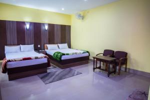 Postel nebo postele na pokoji v ubytování Galaxy Guest House