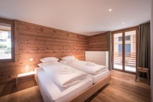 a bedroom with a large bed with wooden walls at Bernstein in Grindelwald