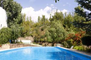 a swimming pool with trees in the background at Camping Alpujarras in Laroles