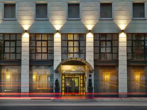 a large building with a clock on the front of it at K+K Hotel am Harras in Munich