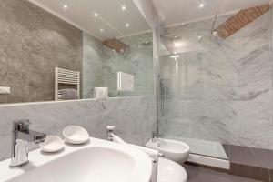 a bathroom with a white sink and a shower at De Rustici Apartment in Florence
