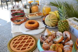 a table topped with lots of different types of breakfast foods at Rais in San Vito lo Capo