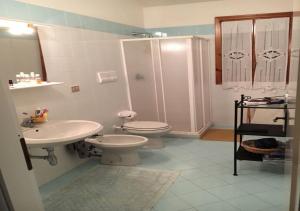 a bathroom with a toilet and a sink and a shower at Casa Asparagi in San Teodoro +29 photos