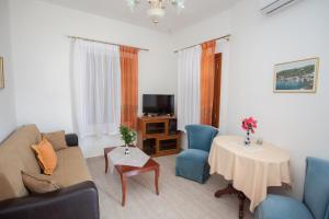 a living room with a couch and a table at Villa Zacharo in Skala