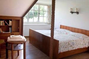 a bedroom with a bed and a table and a window at Punta Del Corno Agriturismo in San Felice del Benaco
