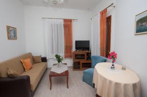 a living room with a couch and a table at Villa Zacharo in Skala