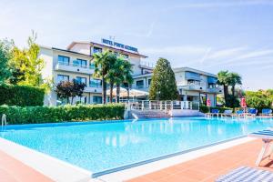 a large swimming pool in front of a hotel at Hotel Porto Azzurro in Sirmione