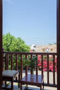 a vase on a table on a balcony with flowers at Villa Zacharo in Skala