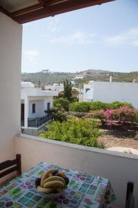 a table with bananas and fruit on top of a balcony at Villa Zacharo in Skala