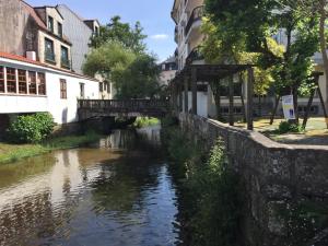 a bridge over a river in a city at ALBERGUE de Caldas de Reis URRACA in Caldas de Reis