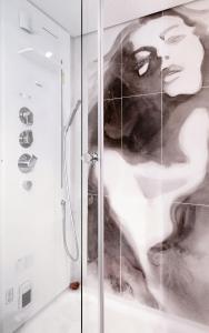 a shower stall with a mural of a woman at Piazza di Spagna Suite de Charme in Rome