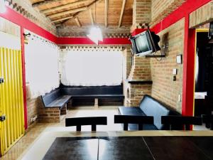 a room with a couch and a tv in it at Cabañas La Carolina - Mesa de Los Santos in Los Santos