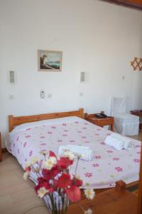 a bedroom with a bed with flowers on it at Villa Zacharo in Skala