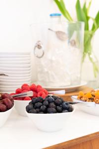 a white bowl of fruit on a table at Trevose Harbour House in St Ives