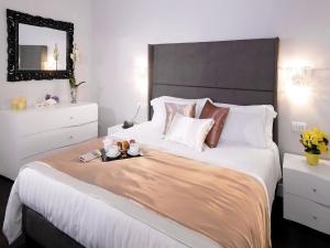 a bedroom with a large white bed with a mirror at Piazza di Spagna Suite de Charme in Rome