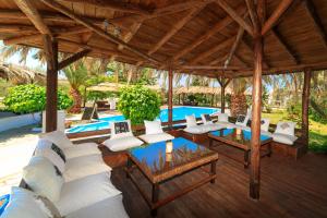 an outdoor patio with white furniture and a pool at Kissos Apartments in Vourvourou
