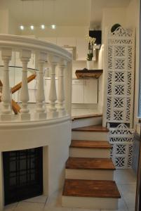 a white staircase with a fireplace in a kitchen at Domus Antiqua San Lorenzo in Genoa