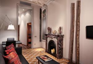a living room with a fireplace and a couch at Hotel Balmes, a member of Preferred Hotels & Resorts in Barcelona