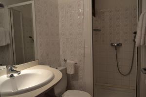 a bathroom with a sink and a toilet and a shower at Hostal l'Esplai in Viladamat