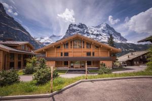 a house with a mountain in the background at Bernstein in Grindelwald