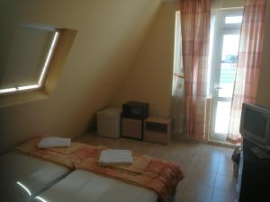 a small bedroom with a bed and a window at Femili Hotel Diveda in Sveti Vlas