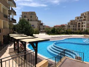 a swimming pool with stairs next to a building at VP Luxor Studio in Sveti Vlas