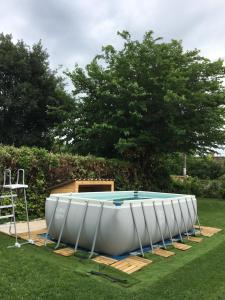 a large white tub sitting in the grass at Maison de village in Velleron