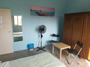 a room with a bed, chair, desk and a lamp at Venice Lagoon House B&B in Tessera