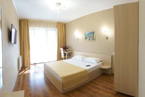 a hotel room with a bed and a window at Darya Hotel in Alushta