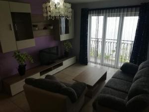 a living room with a couch and a tv at Apartman BubaMara in Sveti Juraj