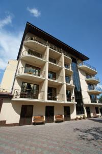 a large building with benches in front of it at Darya Hotel in Alushta