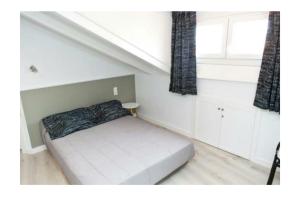 a small bed in a room with a window at LOFT Centro Ribadesella in Ribadesella