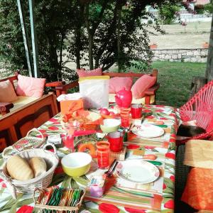 einen Tisch mit einem Tischtuch mit Essen drauf in der Unterkunft B&B Il tempo del sogno con cani e gatti Pet&Breakfast in Baveno