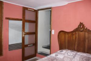 a bedroom with a bed and a mirror at location vacances 5 place des moulieres in Saint-Julien-du-Verdon