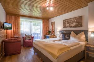 Postel nebo postele na pokoji v ubytování otto steiner appartements pension ellmau & wilder kaiser