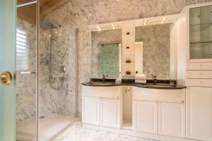 a bathroom with two sinks and a shower at Chalet Sunshine in Saas-Fee