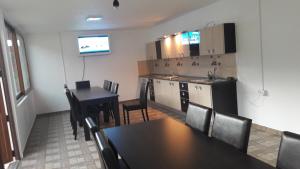 a kitchen and a dining room with a table and chairs at Călăreții lui Țepes in Căpăţîneni-Pămînteni +19 photos