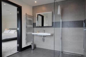 a bathroom with a sink and a shower at Seascapes in Inch