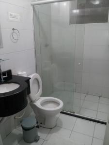 a bathroom with a shower and a toilet and a sink at Opara Palace Hotel in Juazeiro