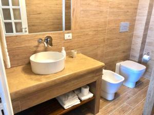 a bathroom with a sink and a toilet at Nettuno Suite in Siracusa +26 photos