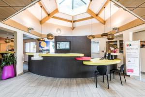 an office with two tables and a counter with chairs at ibis styles Dax Centre in Dax