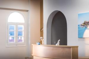 a room with a door and a table and a window at San Georgio Hotel in Agios Georgios Pagon