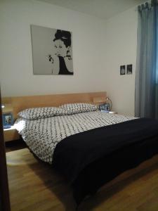 a bedroom with a bed with a black and white comforter at maestral in Banjole