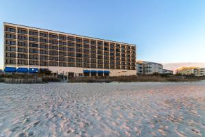 パイン・ノール・ショアーズにあるCrystal Coast Oceanfront Hotelの砂浜の隣のビーチ沿いのホテル