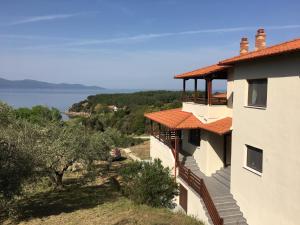 a building with a view of the water at Athinaios Porto Klisouri Villa in Ierissos