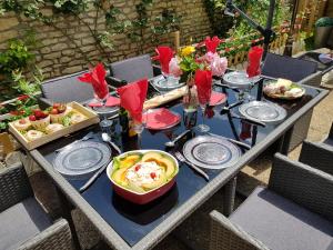 a table topped with plates of food and drinks at Maison le trèfle in Chef-Boutonne