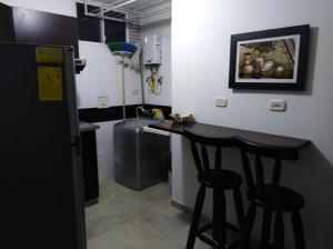 a kitchen with a counter and two bar stools at Apartamento 28U in Bucaramanga