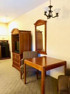 a living room with a table and a mirror at Lyn Aire Motel - Lake George in Lake George